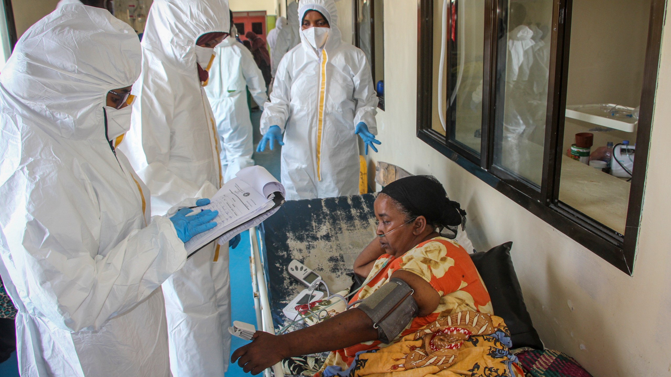 Doctors tend to a patient suffering from COVID-19 and receiving oxygen, in a ward for coronavirus patients at the Martini hospital in Mogadishu, Somalia on Feb. 24, 2021. (Farah Abdi Warsameh/Associated Press)