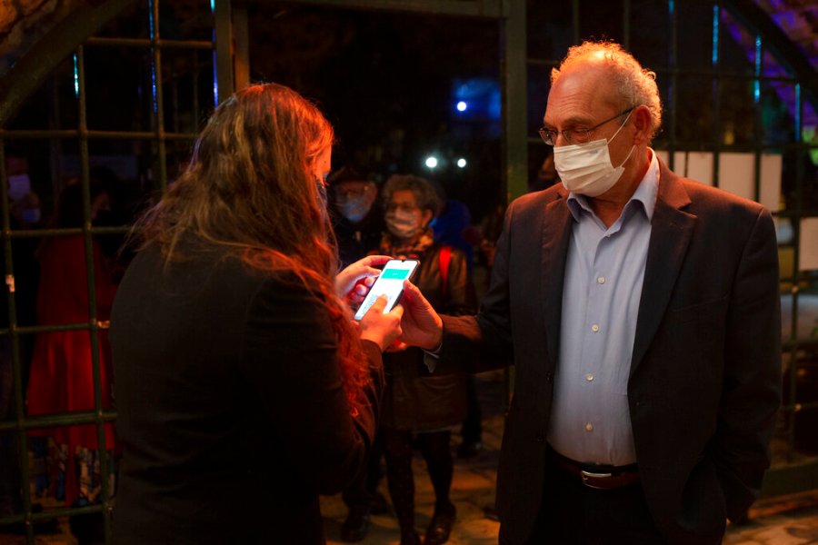 A man presents his "green passport," proof that he is vaccinated against COVID-19, at a theater in Jerusalem on Feb. 23, 2021. (AP Photo/Maya Alleruzzo)