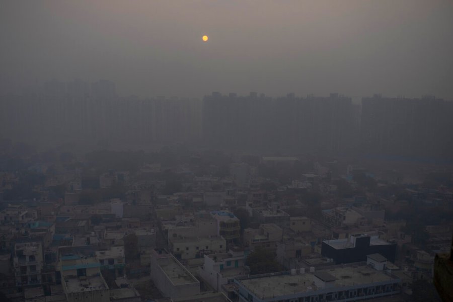 In this Saturday, Jan. 2, 2021 file photo, the morning sun is seen through a blanket of smog on the outskirts of New Delhi, India. (AP Photo/Altaf Qadri)