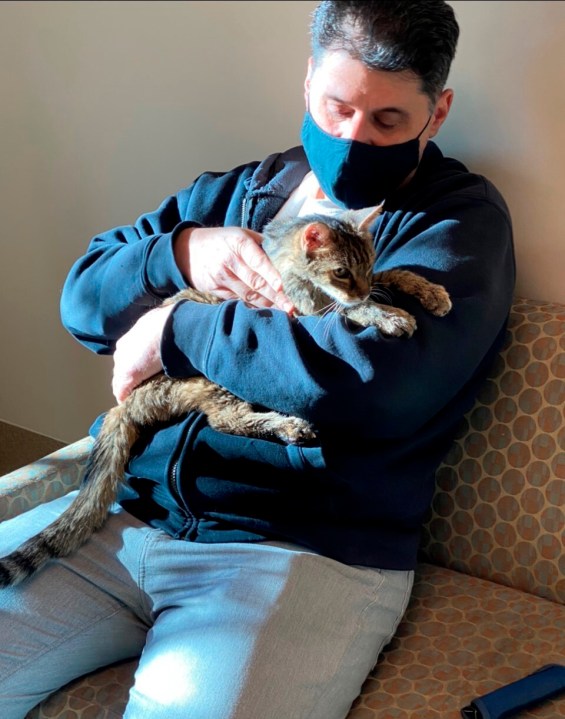 This photo provided by the Los Angeles County Department of Animal Care and Control shows Brandy, a brown tabby cat, that was reunited on Feb. 22, 2021, with her owner, Charles, (he would only give his first name) after she went astray for 15 years. They are seen together at the Palmdale animal care center.