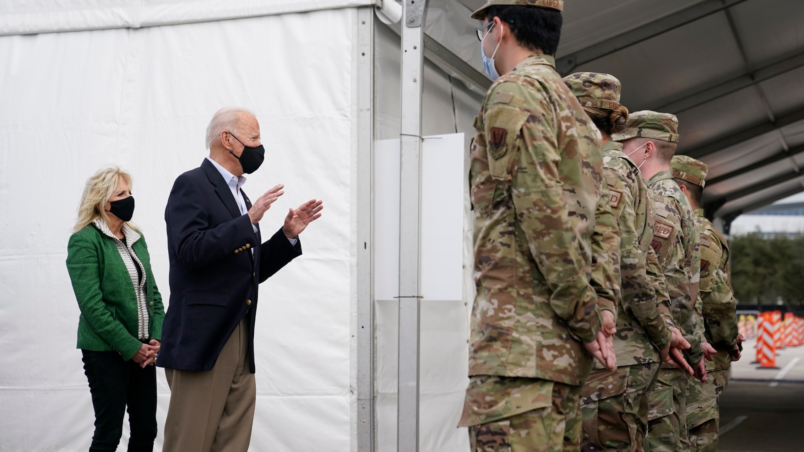 President Joe Biden and first lady Jill Biden meet with troops at a FEMA COVID-19 mass vaccination site at NRG Stadium, Friday, Feb. 26, 2021, in Houston. (AP Photo/Patrick Semansky)