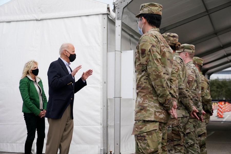 President Joe Biden and first lady Jill Biden meet with troops at a FEMA COVID-19 mass vaccination site at NRG Stadium, Friday, Feb. 26, 2021, in Houston. (AP Photo/Patrick Semansky)