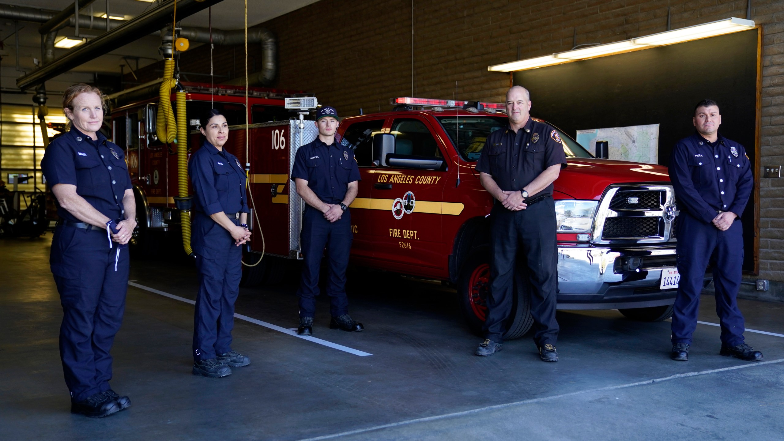 From left, fire Truck Captain Jeane Barrett, firefighter paramedic Sally Ortega, engine probationary firefighter Cole Gomoll, Battalion Chief Dean Douty, and Engine Captain Joe Peña, all first responders from Los Angeles County Fire Department - Station 106, pose for a photo at their station in Rancho Palos Verdes on Feb. 26, 2021. (Ashley Landis / Associated Press)