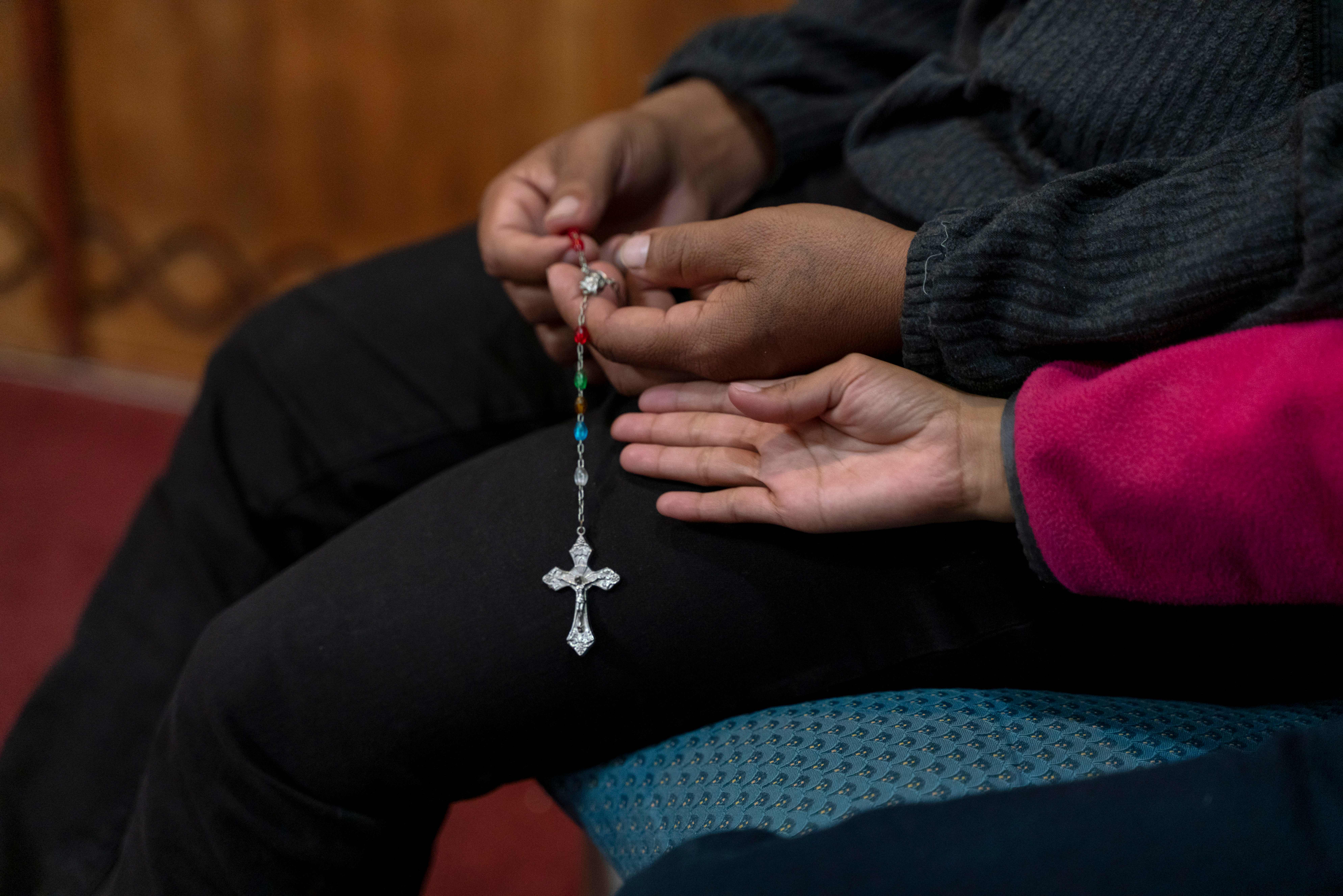 A Guatemalan man prays the Rosary with his daughter in the chapel at Holy Cross Retreat Center, which has been hosting groups of migrants that were part of the 1,300 released by Immigration and Customs Enforcement over the Christmas holiday, in Las Cruces, New Mexico, on Dec. 27, 2018. The shelter takes in groups of migrants weekly, but received this one unexpectedly as did the entire system run by Annunciation House in El Paso, Texas. (Paul Ratje / AFP via Getty Images)