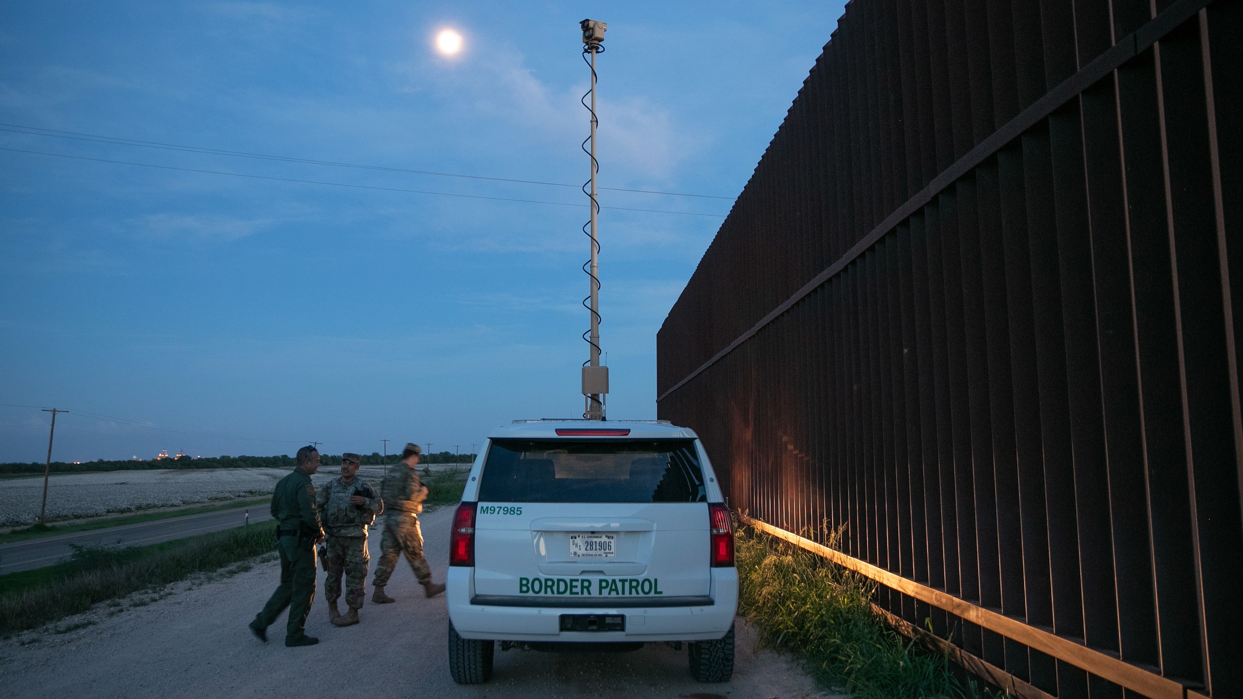 Active duty U.S. Army soldiers and a Border Patrol agent coordinate while manning a high-res surveillance camera at the U.S.-Mexico border fence at dusk on September 10, 2019 in Penitas, Texas. (John Moore/Getty Images)