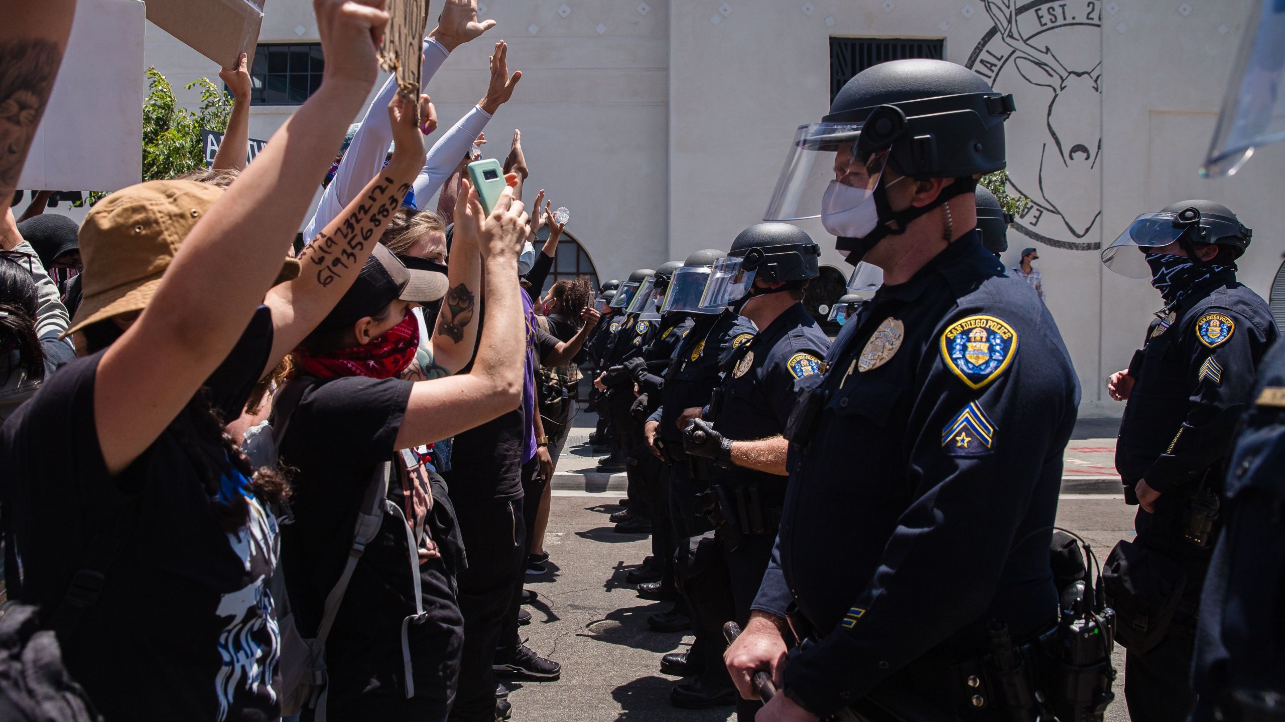 Demonstrators face-off with officers in front of the San Diego Police in downtown San Diego, California on May 31, 2020 as they protest the death of George Floyd. (ARIANA DREHSLER/AFP via Getty Images)