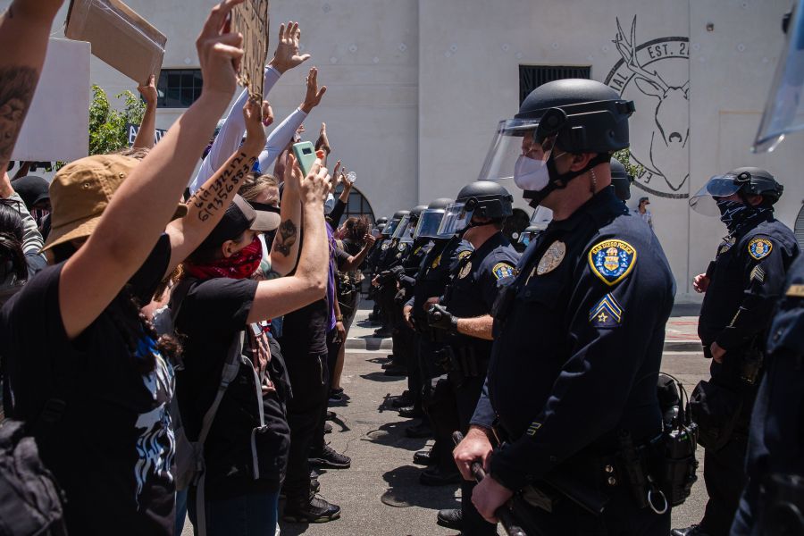 Demonstrators face-off with officers in front of the San Diego Police in downtown San Diego, California on May 31, 2020 as they protest the death of George Floyd. (ARIANA DREHSLER/AFP via Getty Images)