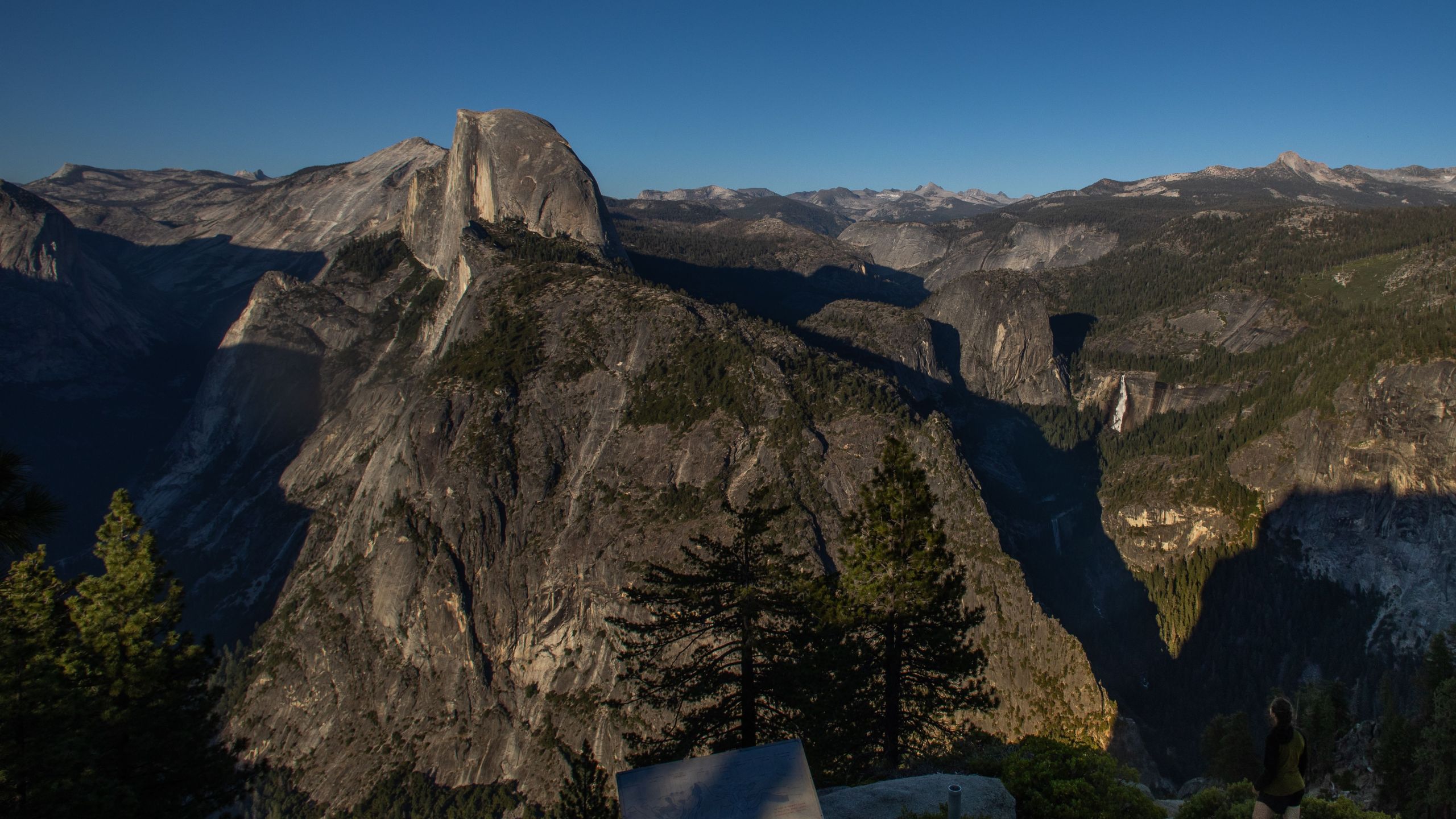 A visitor looks at Yosemite Valley including Half Dome (C L) and Nevada Fall (C R) from the Glacier Point in Yosemite National Park, California on July 06, 2020. (Apu Gomes/AFP via Getty Images)