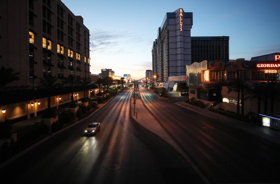 Light traffic passes on a street adjacent to the Las Vegas Strip at dawn, where most businesses have been closed since March 17 in response to the coronavirus (COVID-19) pandemic, on May 27, 2020 in Las Vegas, Nevada.(Mario Tama/Getty Images)