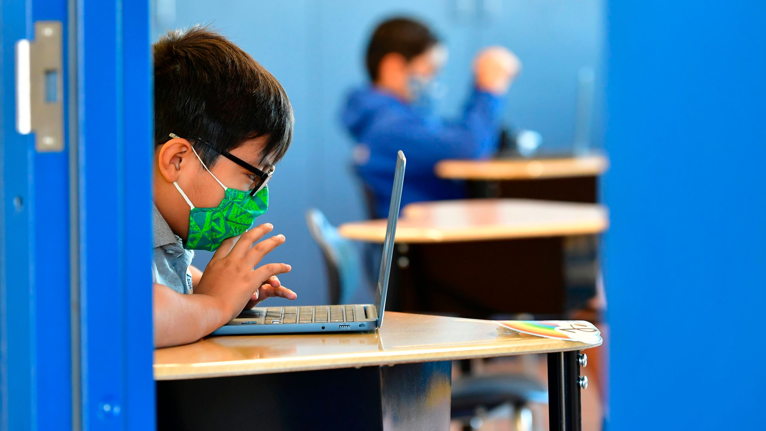 Students work on their laptop computers on Nov. 16, 2020, at St. Joseph Catholic School in La Puente, California, where pre-kindergarten to second grade students in need of special services returned to the classroom for in-person instruction. (FREDERIC J. BROWN/AFP via Getty Images)