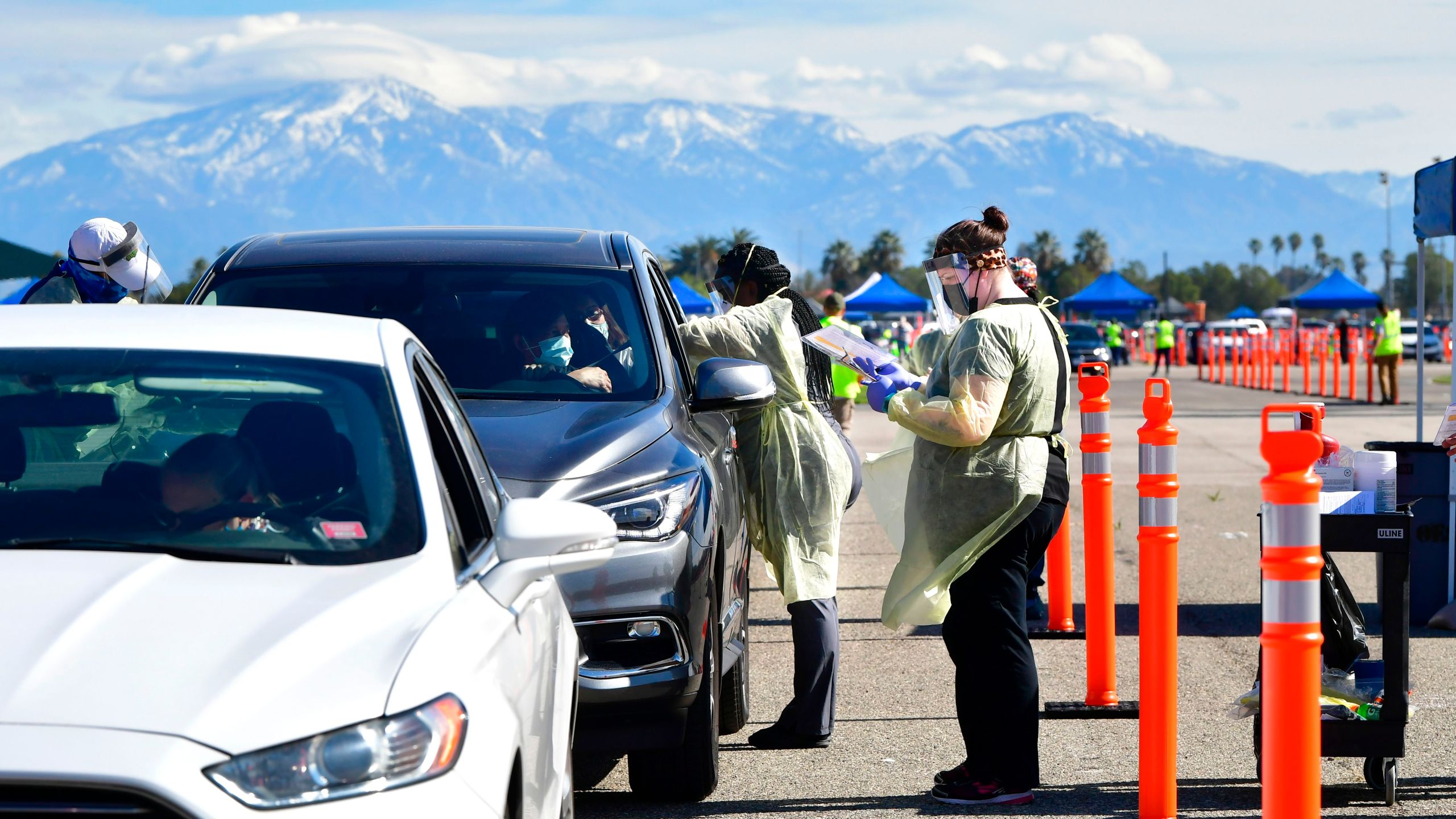 People arrive for their COVID-19 vaccine at the Auto Club Speedway in Fontana on Feb. 2, 2021. (Frederic J. Brown / AFP / Getty Images)