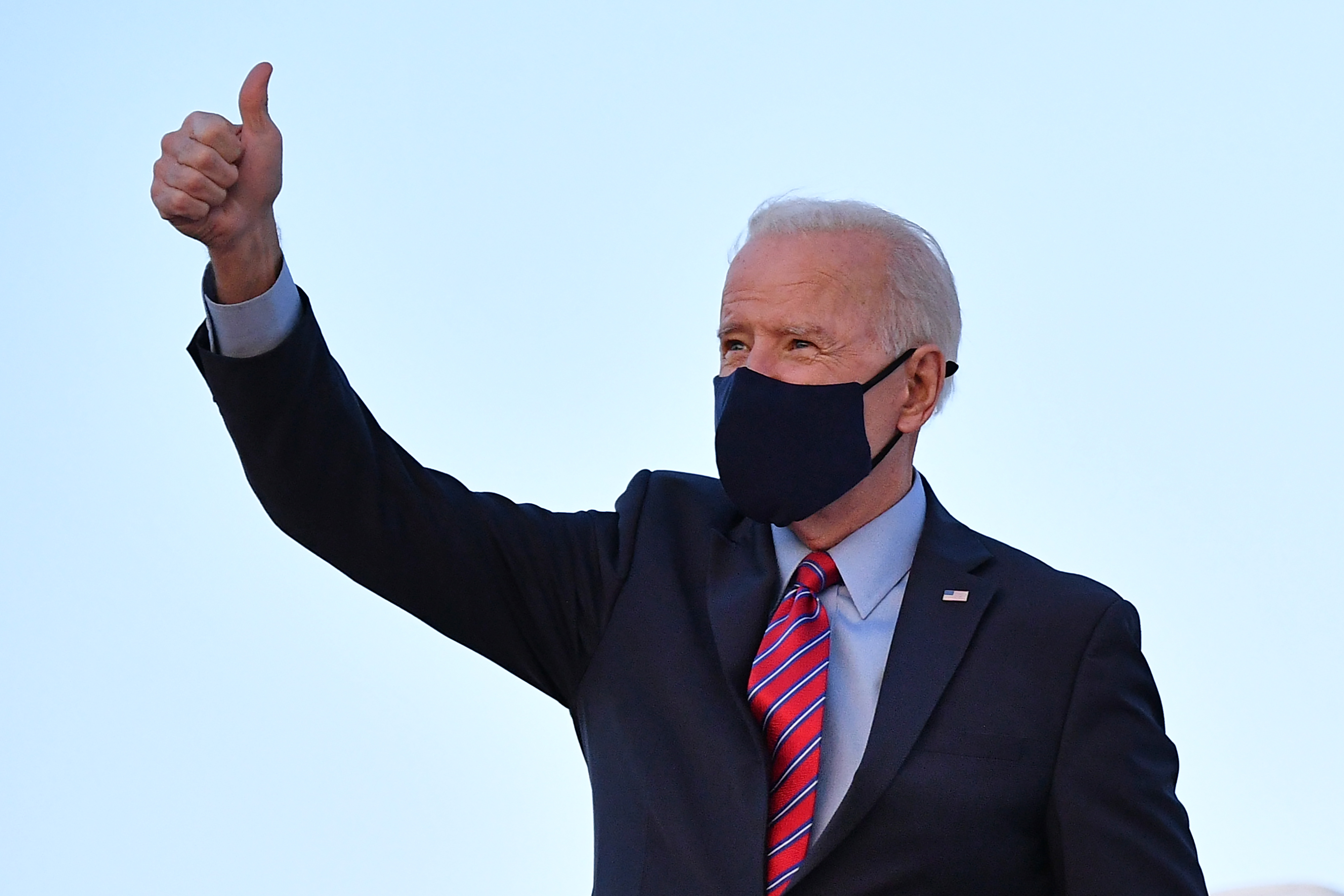 U.S. President Joe Biden gives a thumbs up as he boards Air Force One before departing from Andrews Air Force Base in Maryland on February 5, 2021. (MANDEL NGAN / AFP) (Photo by MANDEL NGAN/AFP via Getty Images)