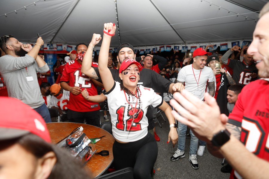 Tampa Bay Buccaneers and Kansas City Chiefs fans watch Super Bowl LV under the Wing House bar and grill watch party tent located near Raymond James Stadium on Feb. 7, 2021 in Tampa, Florida. (Octavio Jones/Getty Images)