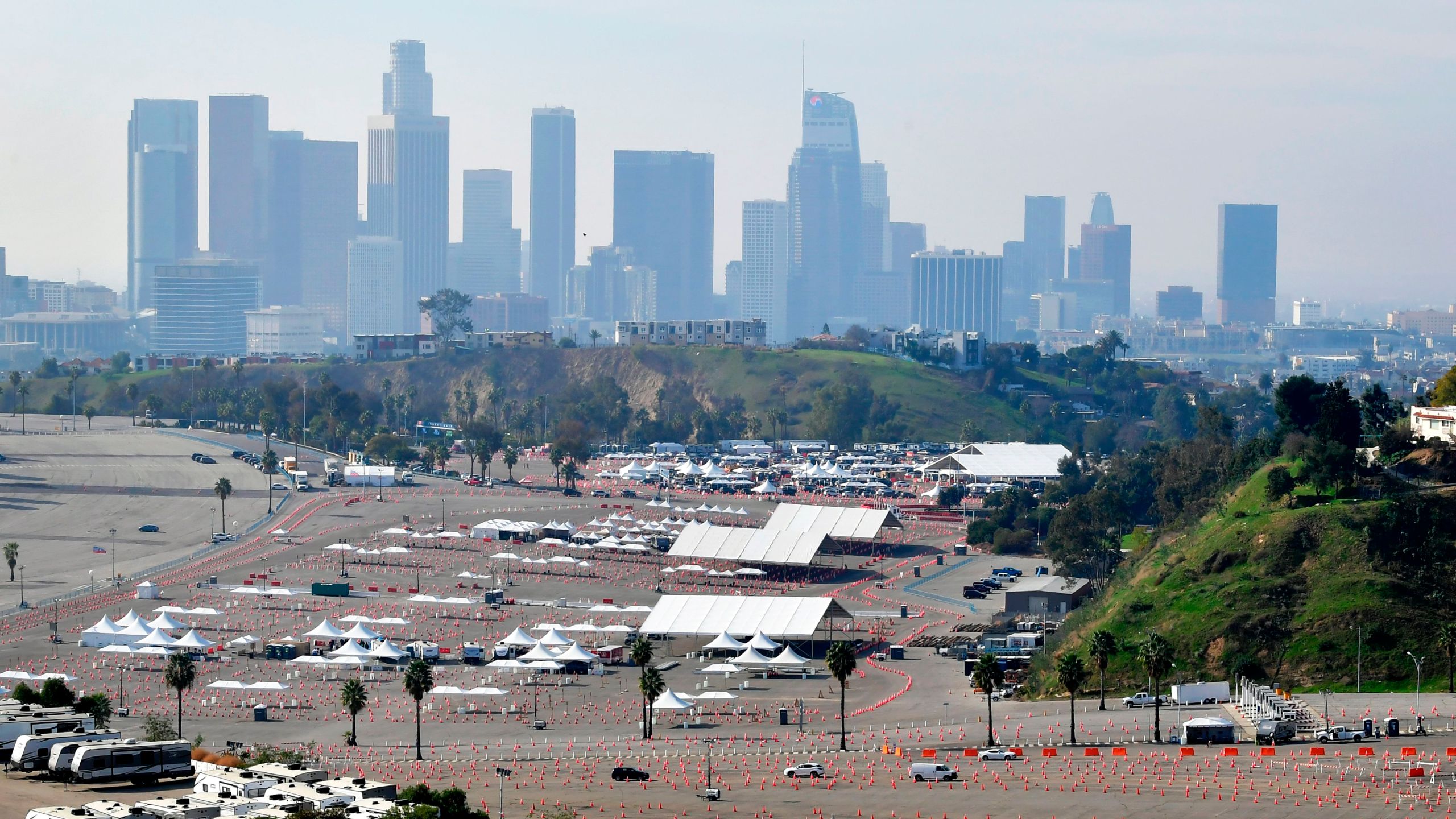 Vehicles make their to a COVID-19 vaccination site at Dodger Stadium in Los Angeles, California on Feb. 11, 2021. (FREDERIC J. BROWN/AFP via Getty Images)