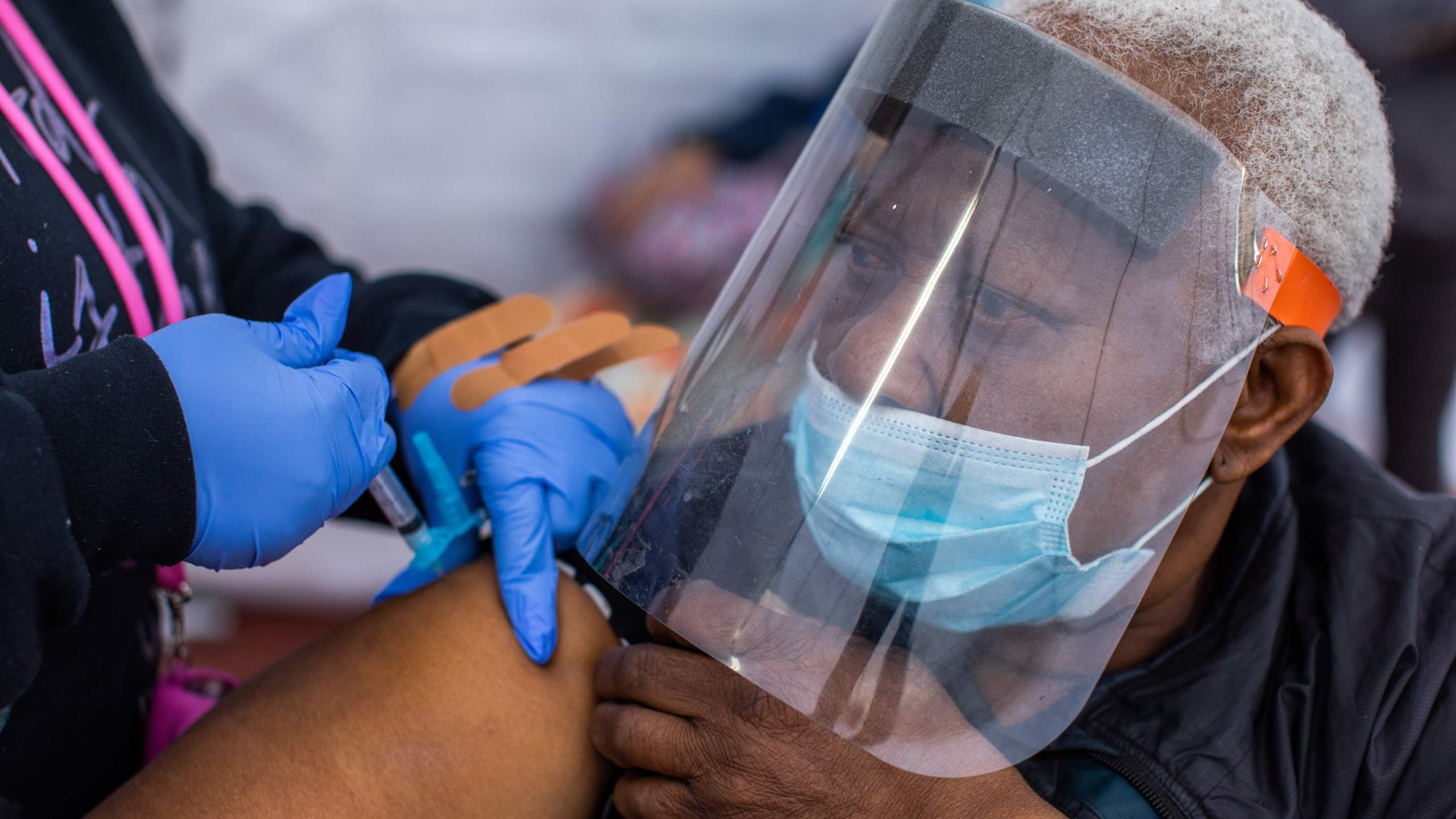 Registered Nurse Ebony Thomas (L) administers a Moderna Covid-19 vaccine to Stella Onwytalu, 89, at Kedren Community Health Center, in South Central Los Angeles, California on February 16, 2021. (Apu Gomes/AFP via Getty Images)