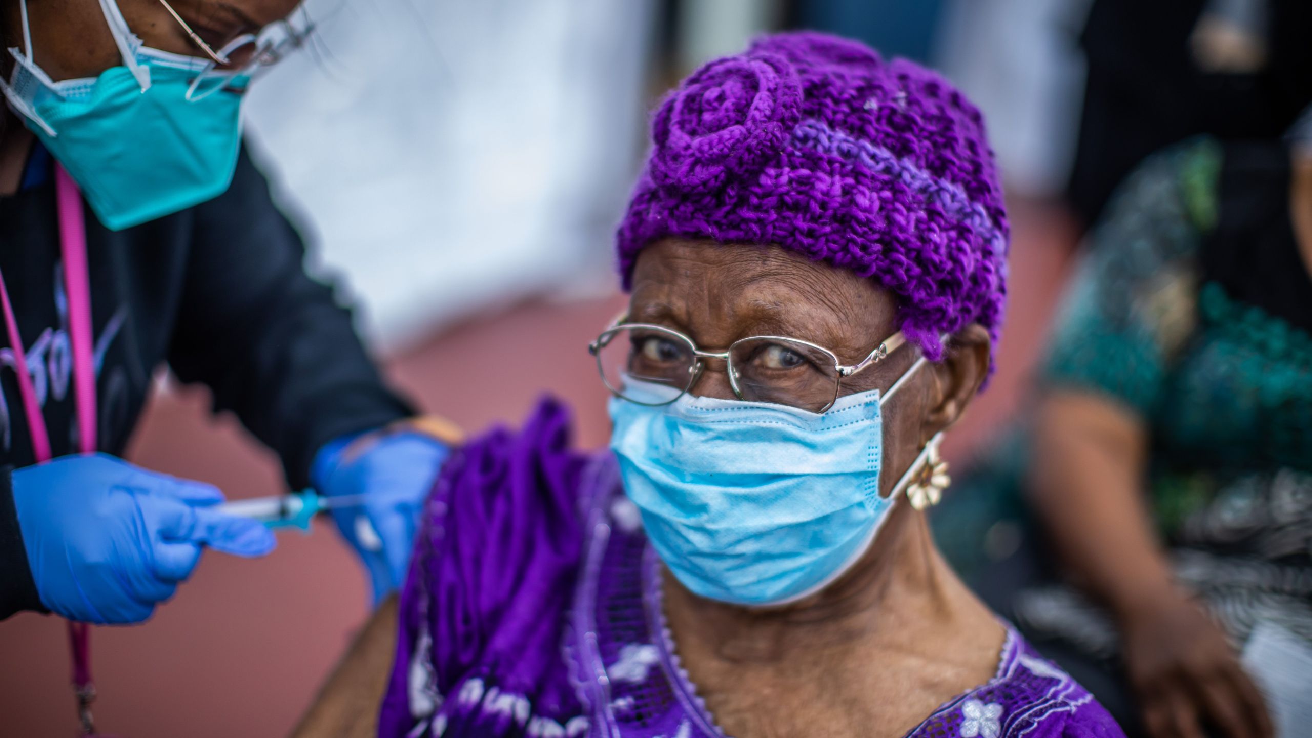 Registered Nurse Ebony Thomas administers a COVID-19 vaccine to Cecilia Onwytalu, 89, at the Kedren Community Health Center in South Los Angeles on Feb. 16, 2021. (Apu Gomes / AFP / Getty Images)