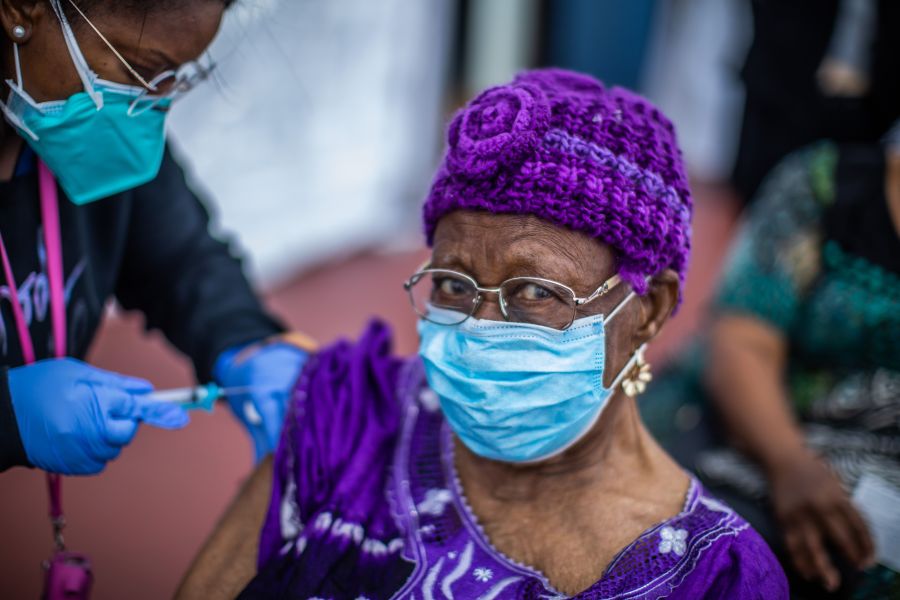 Registered Nurse Ebony Thomas administers a COVID-19 vaccine to Cecilia Onwytalu, 89, at the Kedren Community Health Center in South Los Angeles on Feb. 16, 2021. (Apu Gomes / AFP / Getty Images)