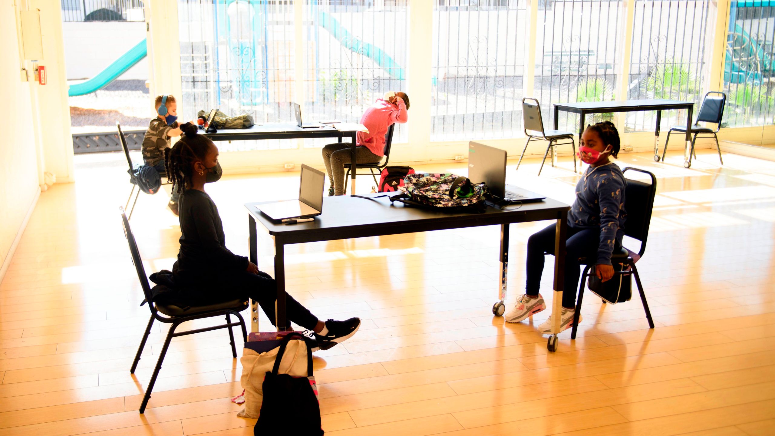 Children attend online classes at a learning hub inside the Crenshaw Family YMCA during the Covid-19 pandemic on February 17, 2021, in Los Angeles, California. (PATRICK T. FALLON/AFP via Getty Images)