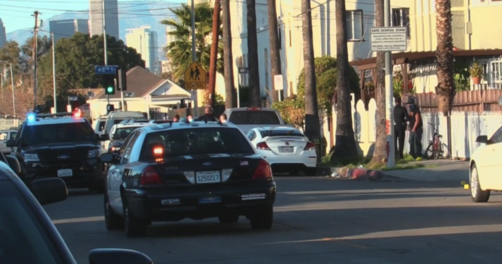 Police vehicles appear at the site of a shooting in South L.A. that left a 13-year-old child wounded. (Onscene.TV)