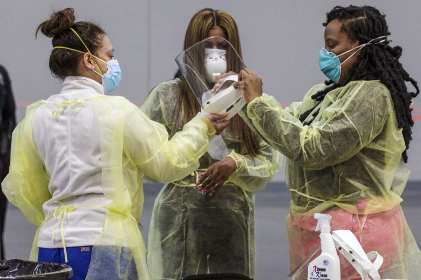 Nurses get ready as the San Bernardino County Department of Public Heath activates the coronavirus vaccination site at the Ontario Convention Center on Thursday in Ontario, Calif.(Irfan Khan / Los Angeles Times)