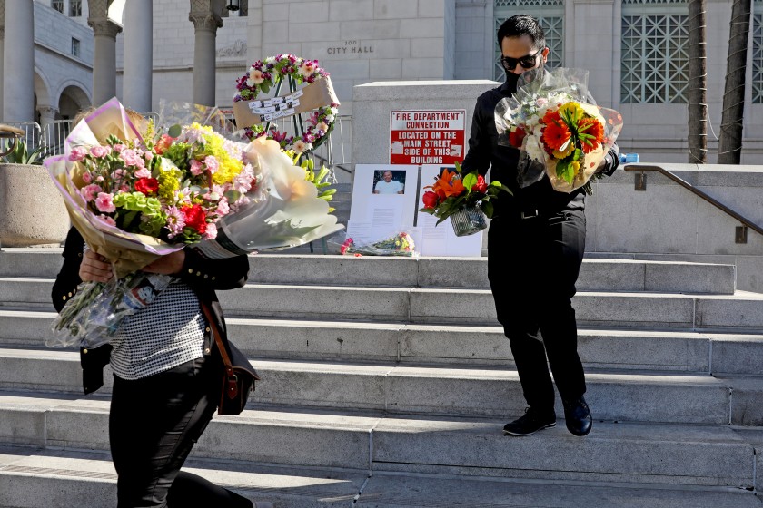 Mourners attend a vigil for Sergio Cafaro, 56, and Daniel Felix, 66, two court interpreters at Los Angeles County Superior Court who died of COVID-19.(Gary Coronado/Los Angeles Times)