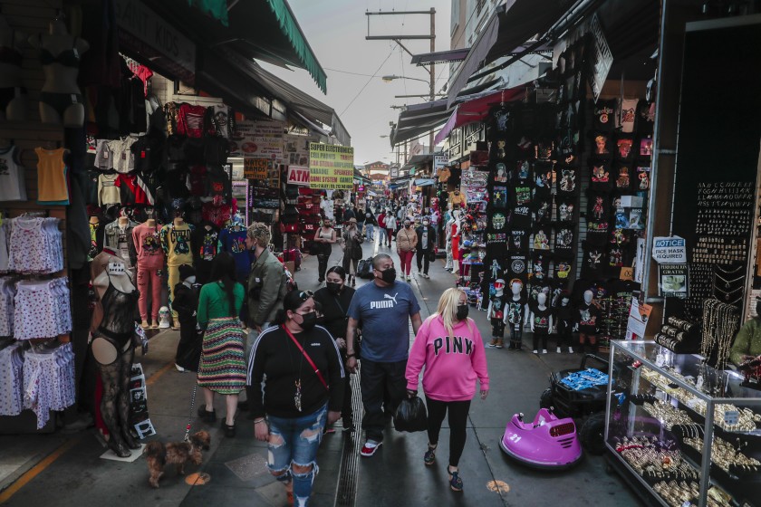 Shoppers walk along Santee Alley in downtown Los Angeles on Feb. 19, 2021. (Robert Gauthier / Los Angeles Times)