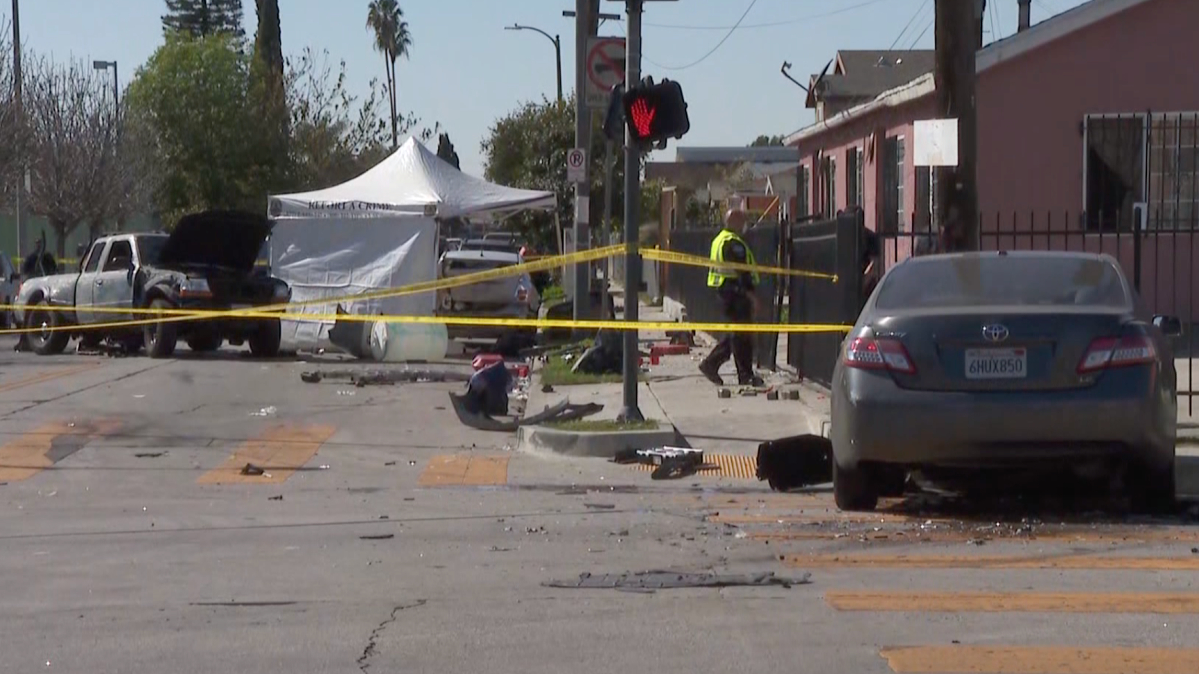 The scene of a crash in South Los Angeles is taped off for investigation after the pickup fatally struck a pedestrian and its occupants fled the scene on Feb. 24, 2021. (KTLA)