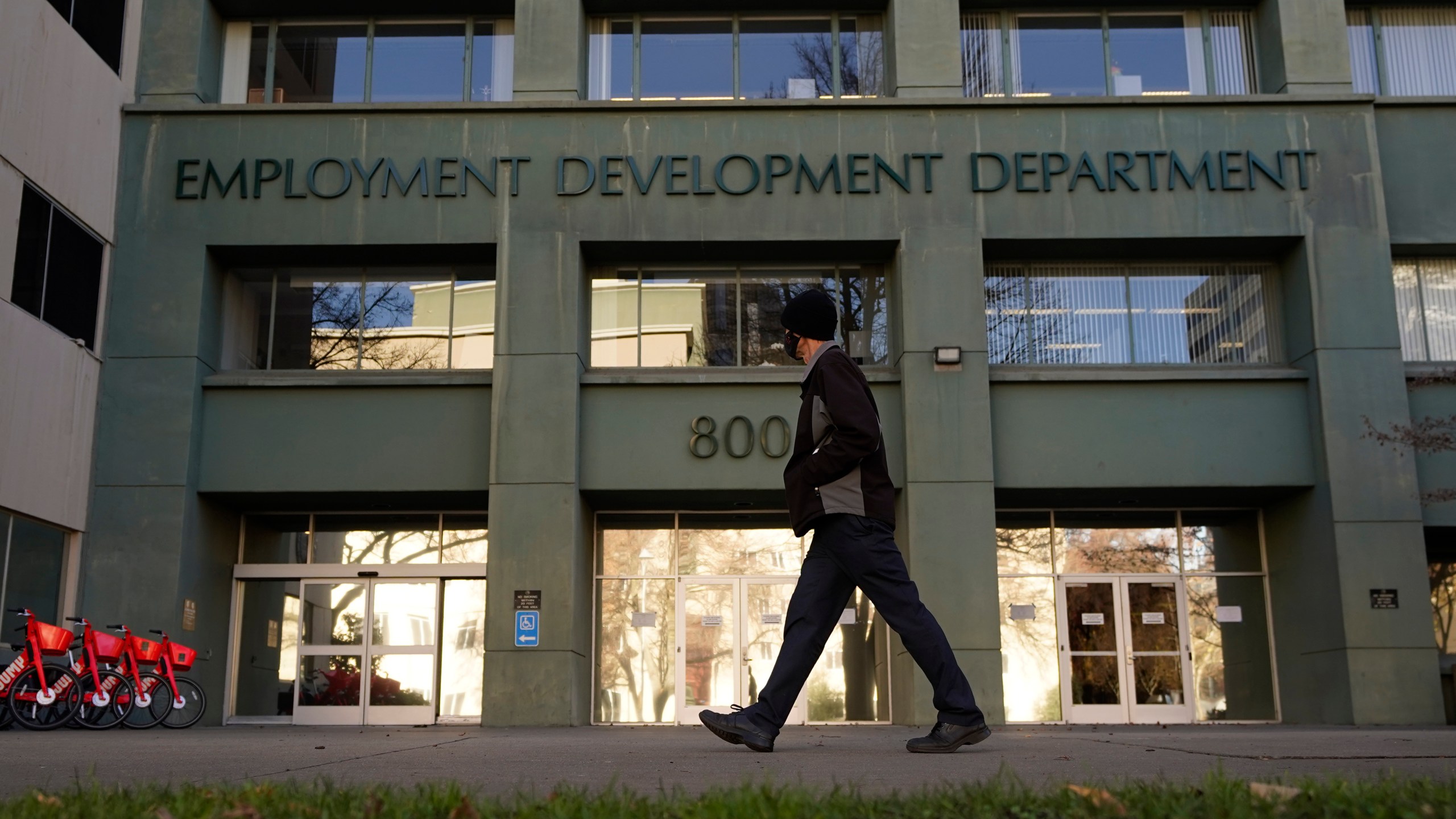 A person passes the office of the California Employment Development Department in Sacramento on Dec. 18, 2020. (Rich Pedroncelli / Associated Press)