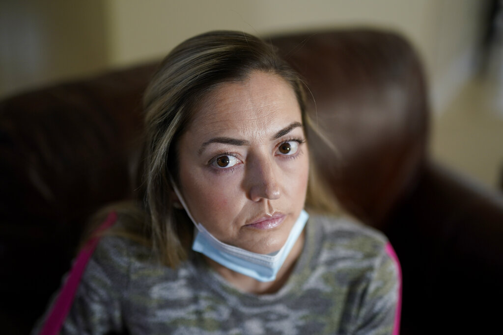 Maura Wozniak poses for a picture on Tuesday, Feb. 23, 2021, in Huntersville, N.C. Wozniak, a 42-year-old mother of 2 has cystic fibrosis and also has undergone lung transplants and has been moved into group 4, just ahead of the general public receive the COVID-19 vaccination. (AP Photo/Chris Carlson)