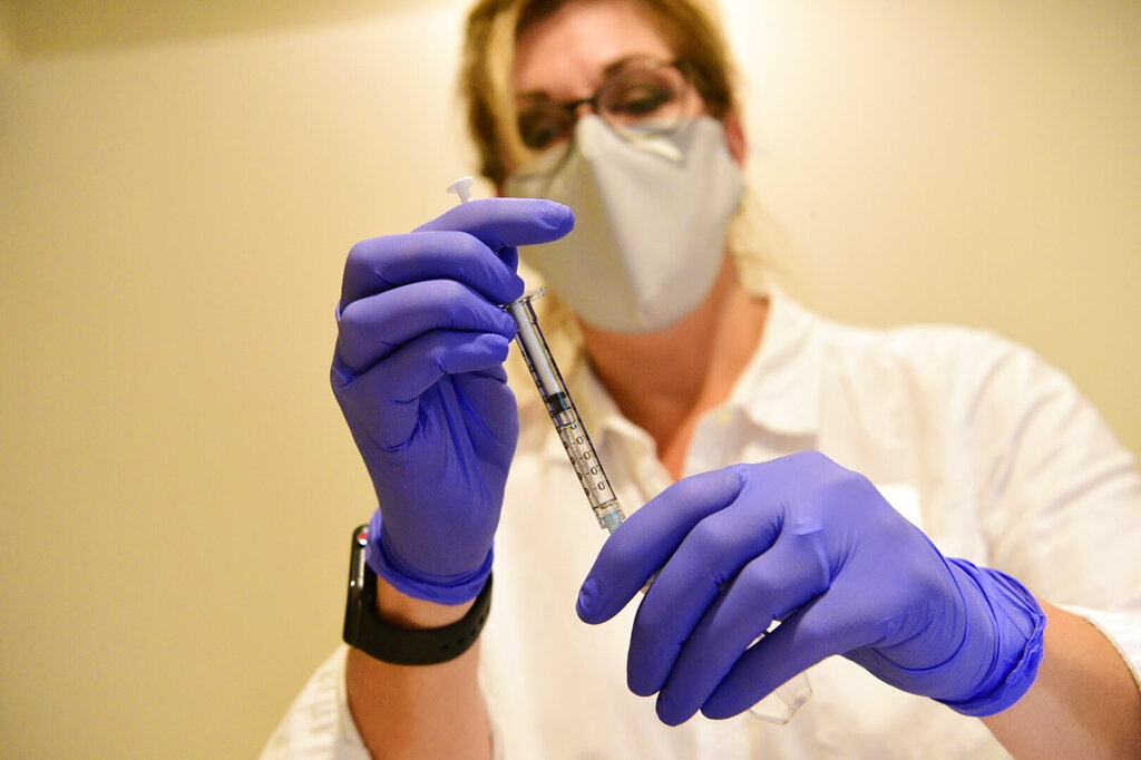 This September 2020, file photo provided by Johnson & Johnson shows a pharmacist preparing to give an experimental COVID-19 vaccine. (Johnson & Johnson via AP, File)