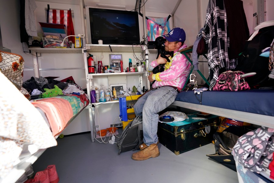 A homeless person sits inside his tiny home on Feb. 25, 2021, in North Hollywood. (AP Photo/Marcio Jose Sanchez)