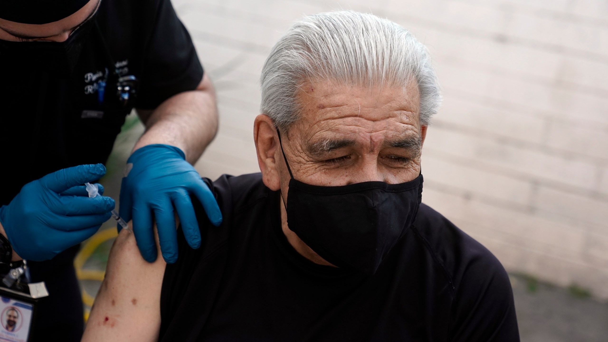 Edward Muro gets a shot of Pfizer's COVID-19 vaccine at Families Together of Orange County Community Health Center in Tustin on Feb. 26, 2021. (Marcio Jose Sanchez / Associated Press)