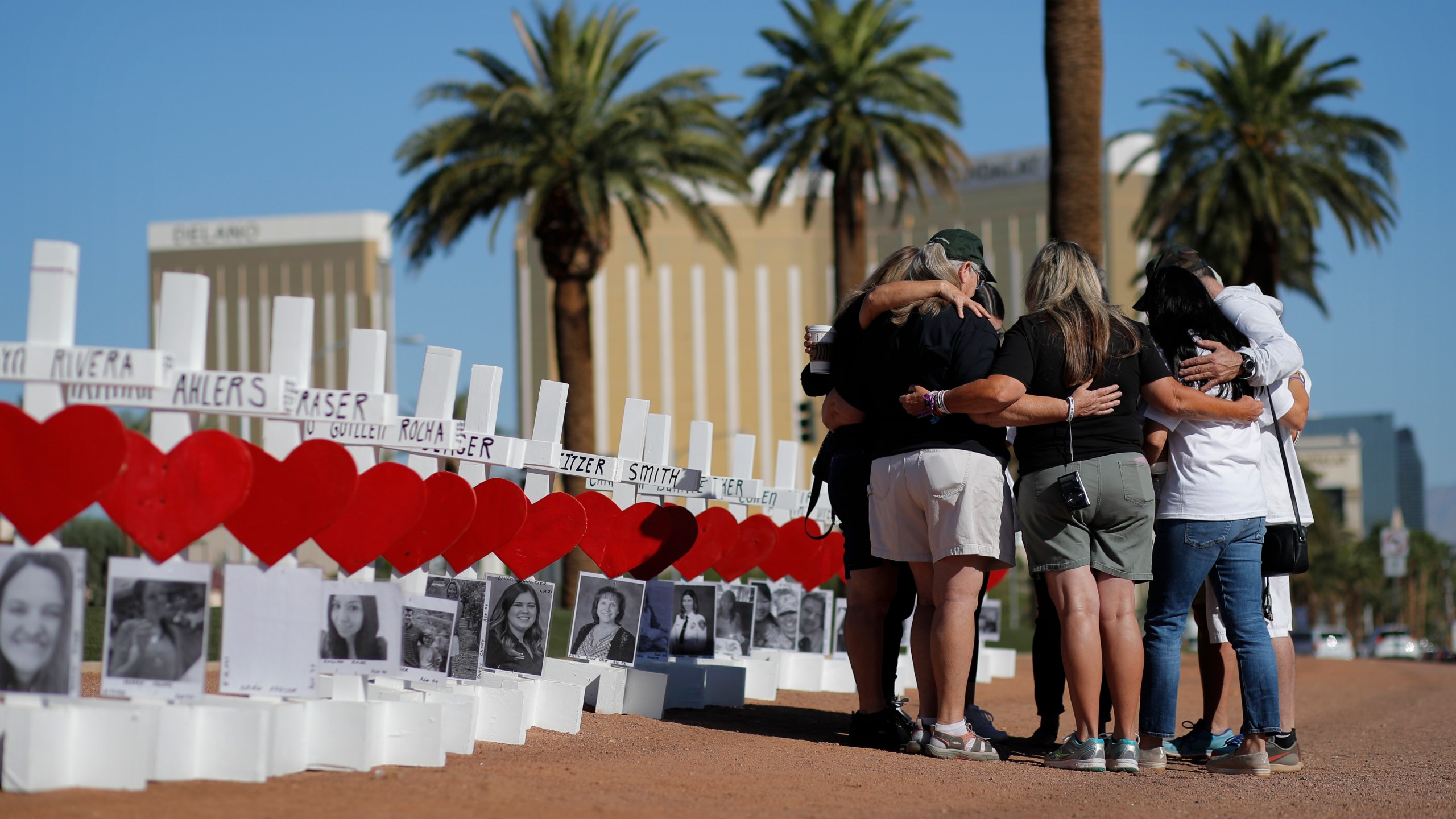 People pray at a makeshift memorial for shooting victims in Las Vegas on Oct. 1, 2019, the anniversary of the mass shooting two years earlier. (John Locher / Associated Press)