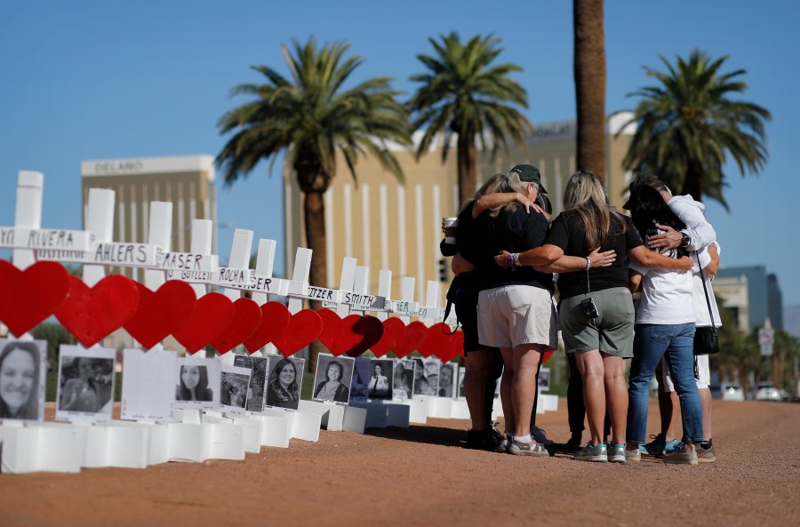 People pray at a makeshift memorial for shooting victims in Las Vegas on Oct. 1, 2019, the anniversary of the mass shooting two years earlier. (John Locher / Associated Press)