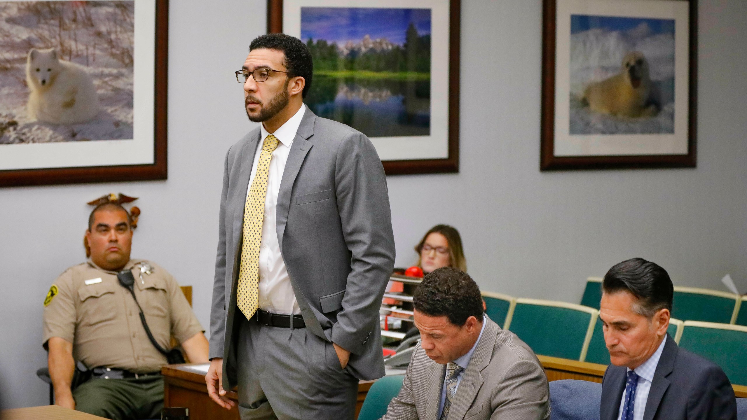 In this June 14, 2019, file photo Ex-NFL player Kellen Winslow II, standing, who was accused of committing several sex crimes against women in North County last year, including rape, answers a question from San Diego County Superior Court Vista Judge Blaine Bowman during a status hearing in Vista, Calif. (Howard Lipin/The San Diego Union-Tribune via AP, Pool,File)