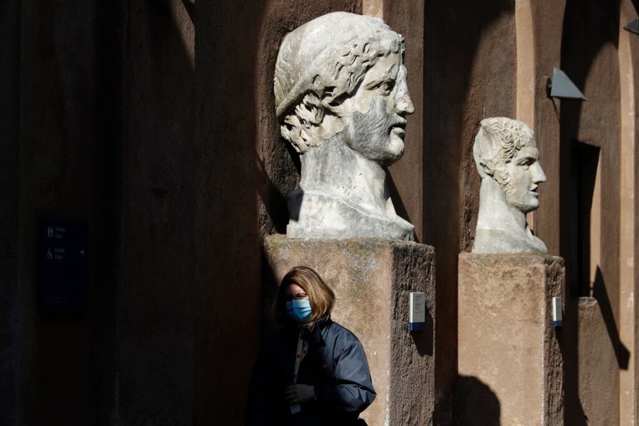 A museum usher stands by marble busts at the entrance of the Sant'Angelo castle In Rome Tuesday, March 2, 2021. (AP Photo/Gregorio Borgia)