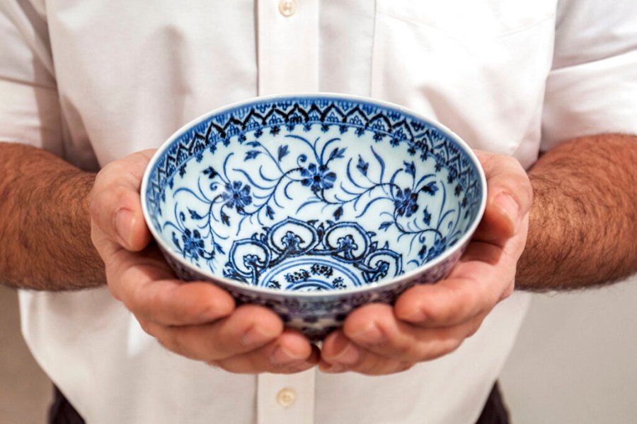 This photo, provided by Sotheby's, in New York, on Tuesday, March 2, 2021, shows a small porcelain bowl bought for $35 at a Connecticut yard sale that turned out to be a rare, 15th century Chinese artifact worth between $300,000 and $500,000. The bowl will be offered in Sotheby's Auction of Important Chinese Art, in New York, on March 17. (Sotheby's via AP)