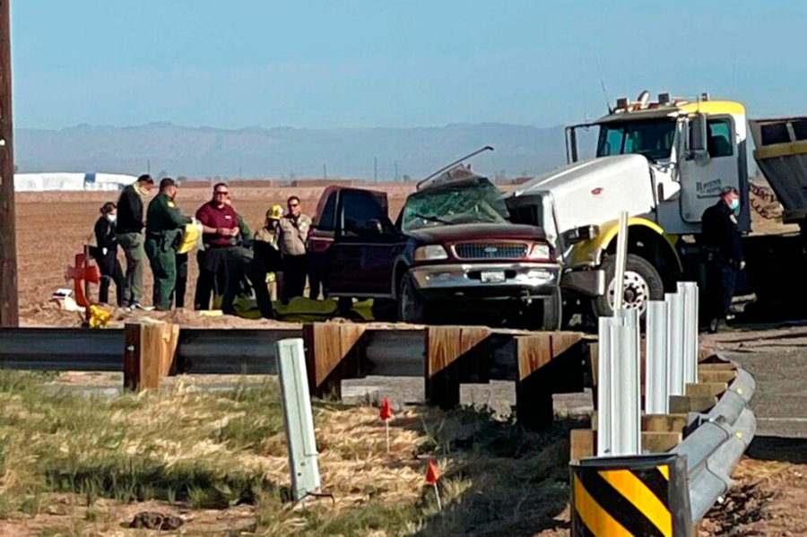 Authorities work at the scene of a deadly crash involving a semitruck and an SUV in Holtville, near the California border with Mexico, on March 2, 2021. (KYMA via Associated Press)