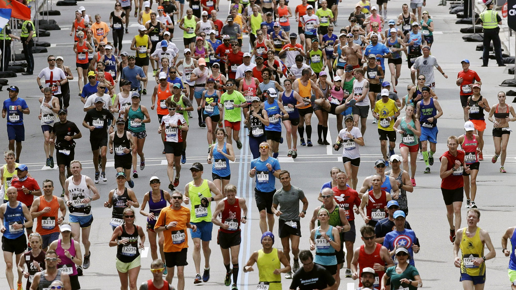 In this April 17, 2017, file photo, runners head down the stretch to the finish line in the 121st Boston Marathon in Boston. (AP Photo/Charles Krupa, File)