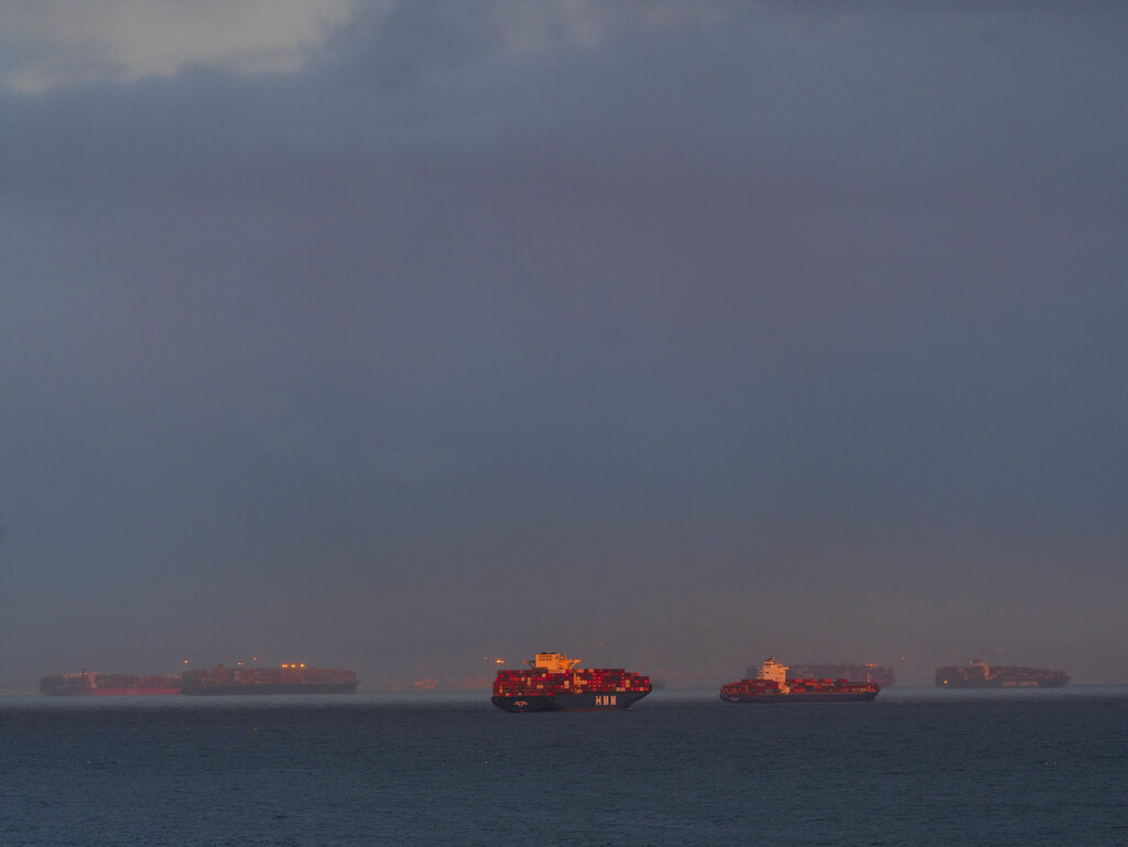 In this Wednesday, March 3, 2021 photo, a high number of container ships dot the coast of Long Beach at sunset waiting to dock at the Ports of Los Angeles and Long Beach off the California Coast. ( AP Photo/Damian Dovarganes)