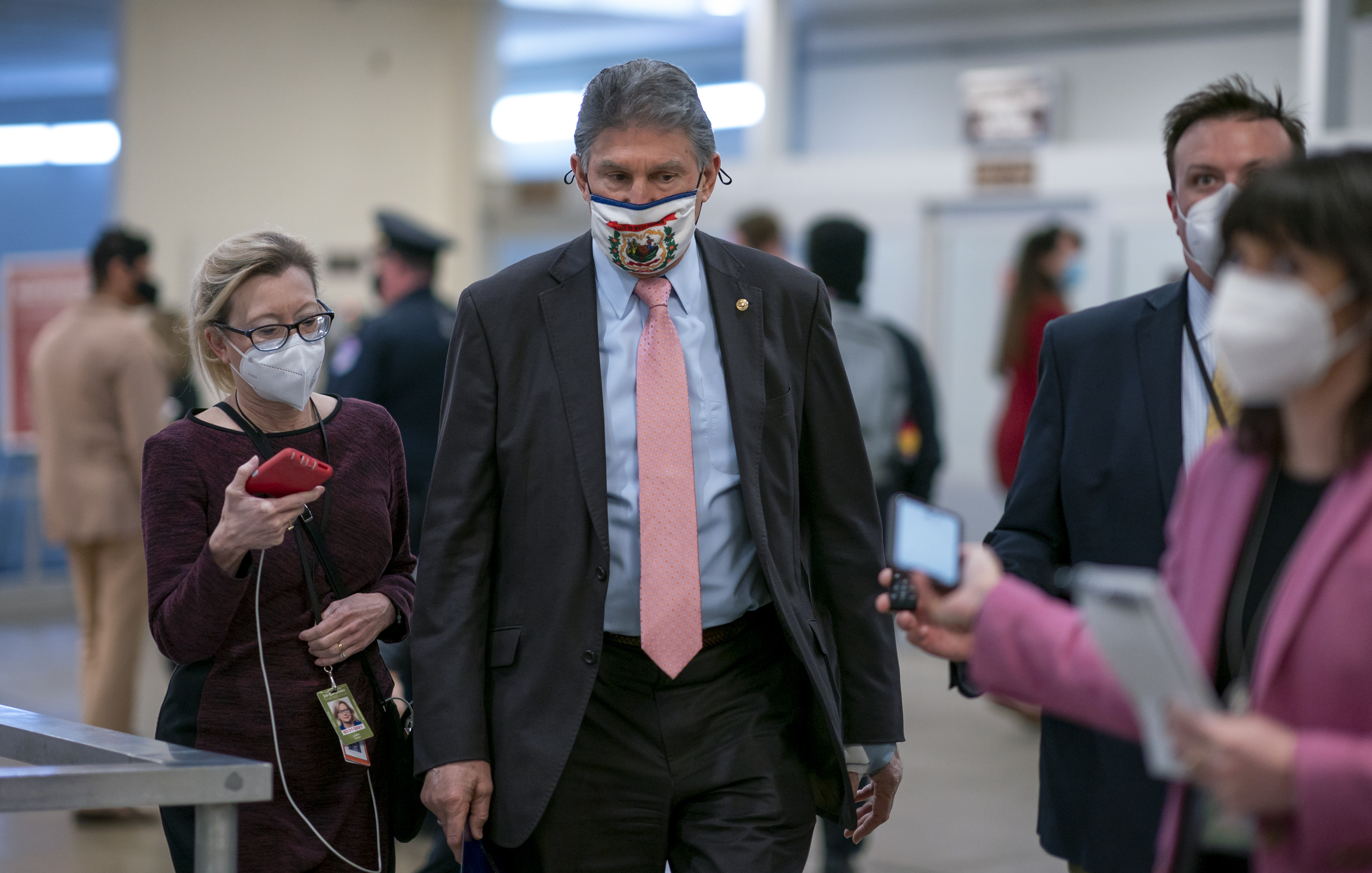 In this Feb. 25, 2021, file photo, reporters question Sen. Joe Manchin, D-W.Va., as he arrives for votes on President Joe Biden's cabinet nominees, at the Capitol in Washington. (AP Photo/J. Scott Applewhite, File)