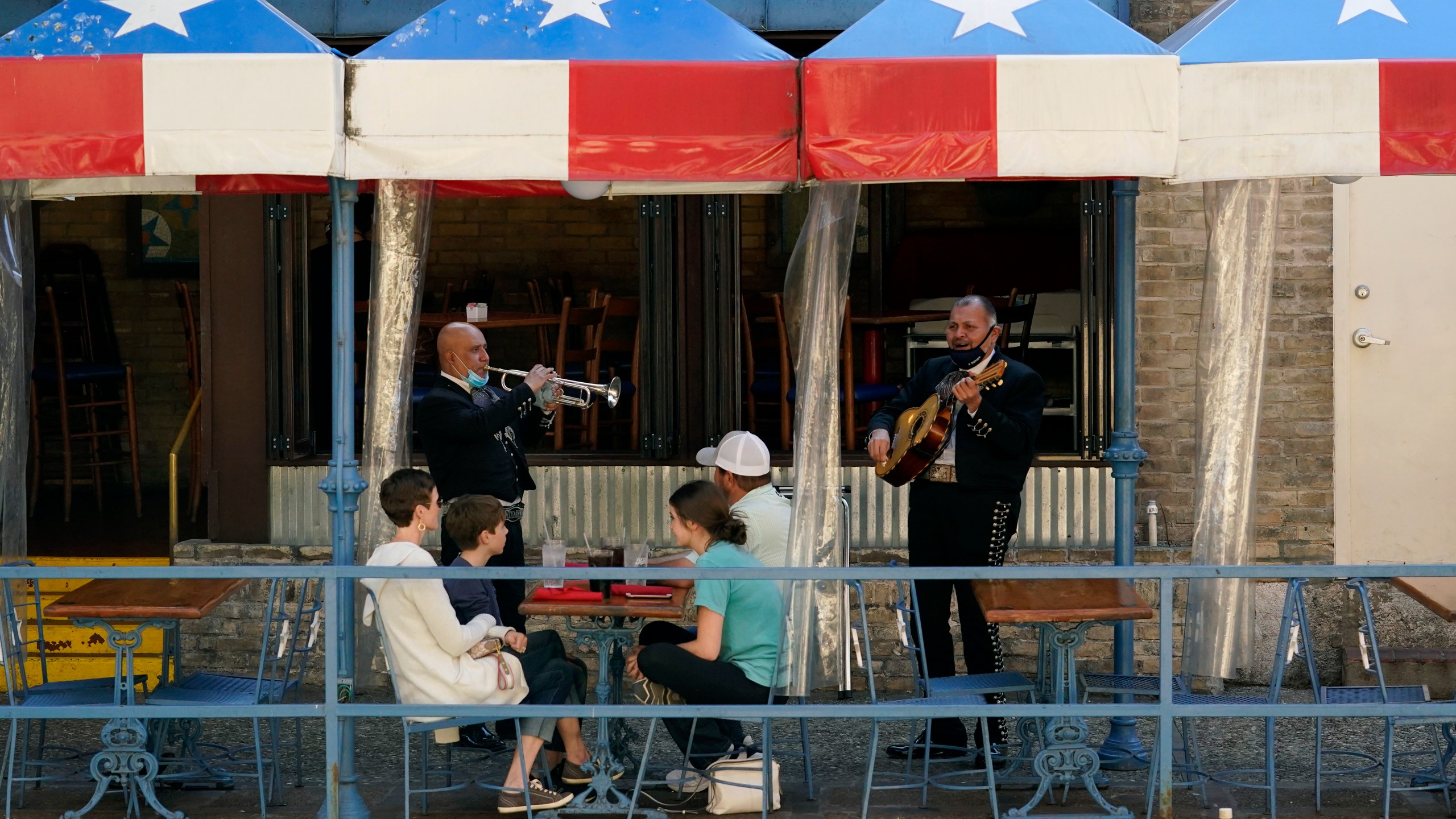 Mariachi perform for diners at a restaurant on the River Walk in San Antonio on March 3, 2021. (Eric Gay / Associated Press)