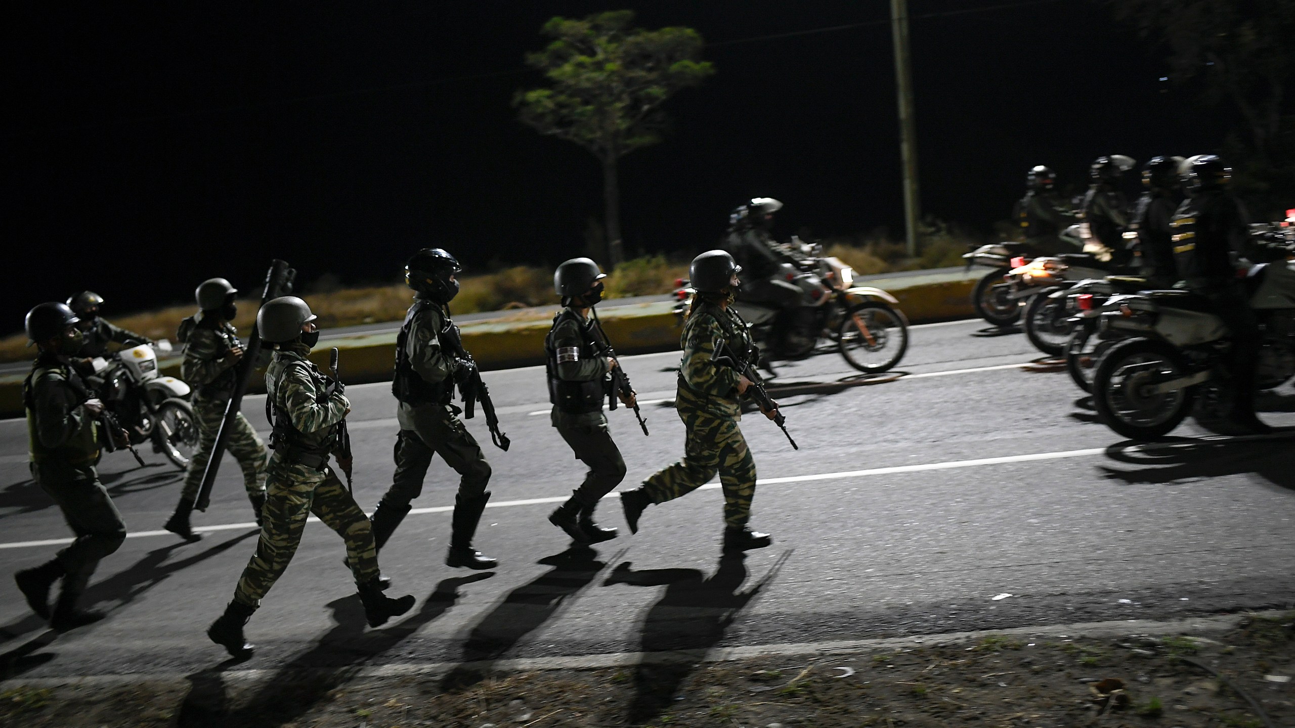 Security forces take part in a military drill to mark the eighth death anniversary of President Hugo Chavez in Caracas, Venezuela on March 5, 2021. (Matias Delacroix/Associated Press)