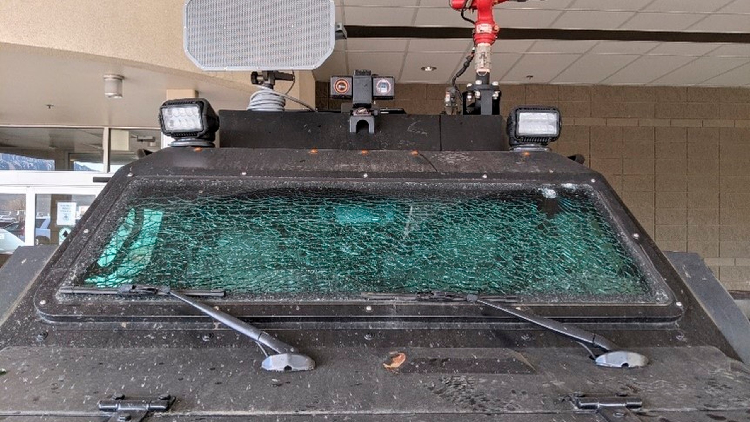 This Sunday, March 7, 2021, photo released by the City of Boulder shows the smashed windshield of a Terradyne light armored patrol vehicle at the Boulder Police Department in Boulder, Colo. (Boulder Police Department/ City of Boulder via AP)