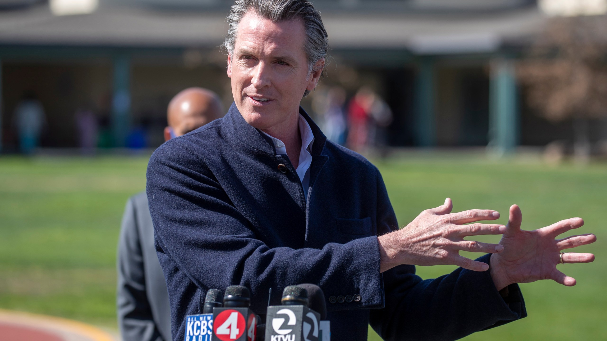 California Gov. Gavin Newsom speaks about the state's plan to reopen schools as coronavirus vaccinations continue during a news conference on the schoolyard at Barron Park Elementary in Palo Alto on March 2, 2021. (Karl Mondon / Bay Area News Group via Associated Press)