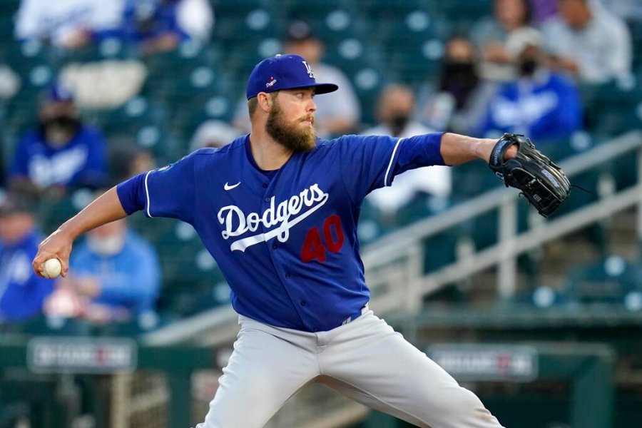 Los Angeles Dodgers starting pitcher Jimmy Nelson throws a pitch against the Cincinnati Reds during the first inning a spring training baseball game Tuesday, March 9, 2021, in Goodyear, Ariz. (AP Photo/Ross D. Franklin)