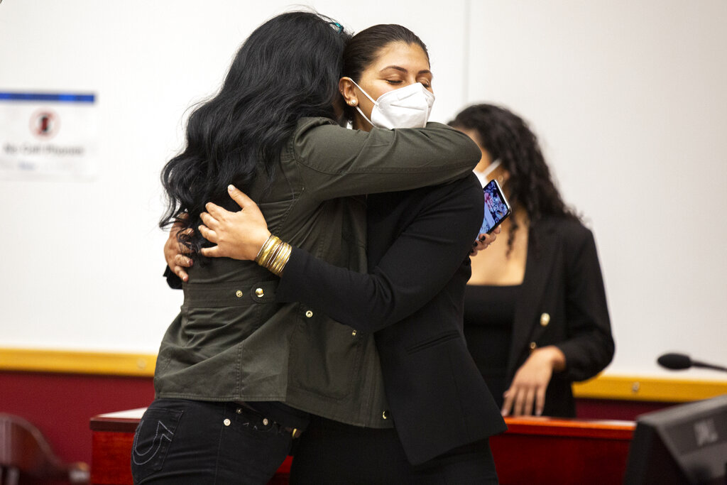 Des Moines Register reporter Andrea Sahouri, facing, hugs her mother, Muna Tareh-Sahouri, after being found not-guilty at the conclusion of her trial at the Drake University Legal Clinic, Wednesday, March 10, 2021, in Des Moines, Iowa. (Kelsey Kremer/The Des Moines Register via AP, Pool)