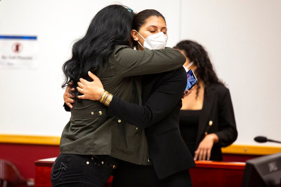 Des Moines Register reporter Andrea Sahouri, facing, hugs her mother, Muna Tareh-Sahouri, after being found not-guilty at the conclusion of her trial at the Drake University Legal Clinic, Wednesday, March 10, 2021, in Des Moines, Iowa. (Kelsey Kremer/The Des Moines Register via AP, Pool)