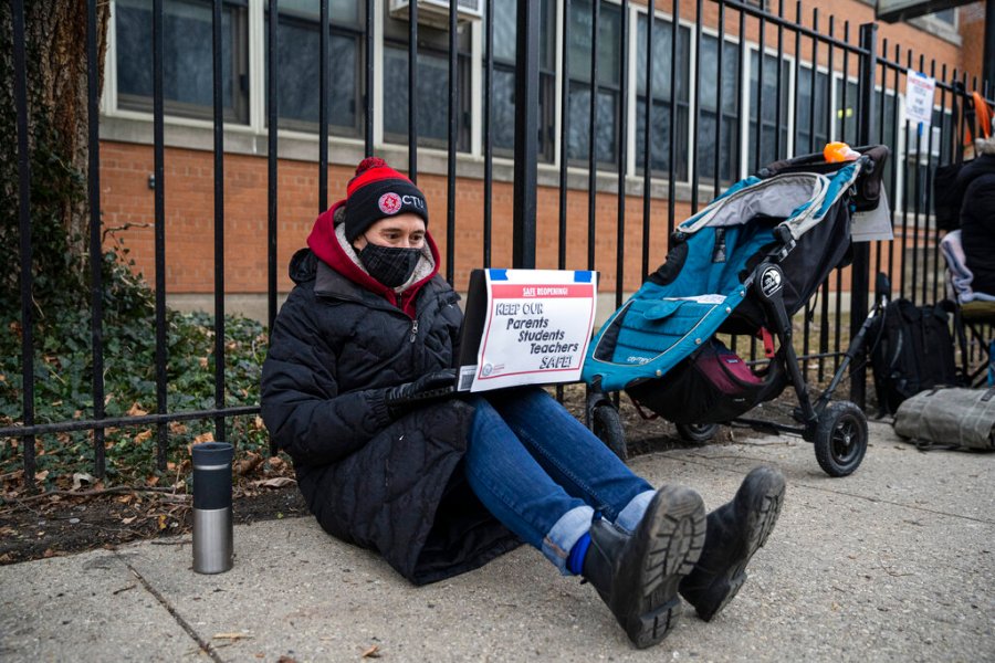 In this Jan. 11, 2021 file photo, a Suder Montessori Magnet Elementary School teacher speaks to students during a virtual class outside of the school in solidarity with pre-K educators forced back into the building in Chicago. (Anthony Vazquez/Chicago Sun-Times via AP, File)