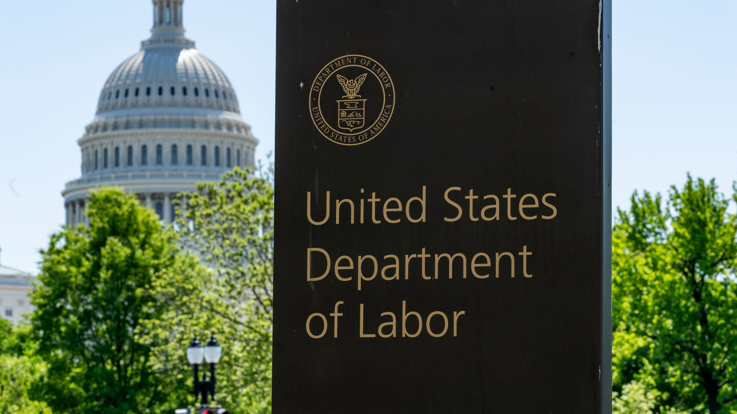 In this May 7, 2020, file photo, the entrance to the Labor Department is seen near the Capitol in Washington. Unemployment fraud in the U.S. has reached dramatic levels during the pandemic: more than $63 billion has been paid out improperly through fraud or errors since March 2020. Criminals are seizing on the opportunity created by the pandemic and are making false claims using stolen information. (AP Photo/J. Scott Applewhite, File)